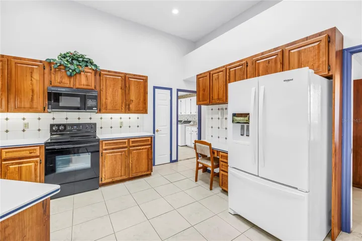 Garage access, large walk-in pantry, laundry room, all on this side of the house.  Newer refrigerator.