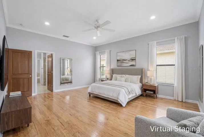 Virtual staging and updating of the previous two photos showing recessed lighting, hardwood flooring, new paint and staged furniture