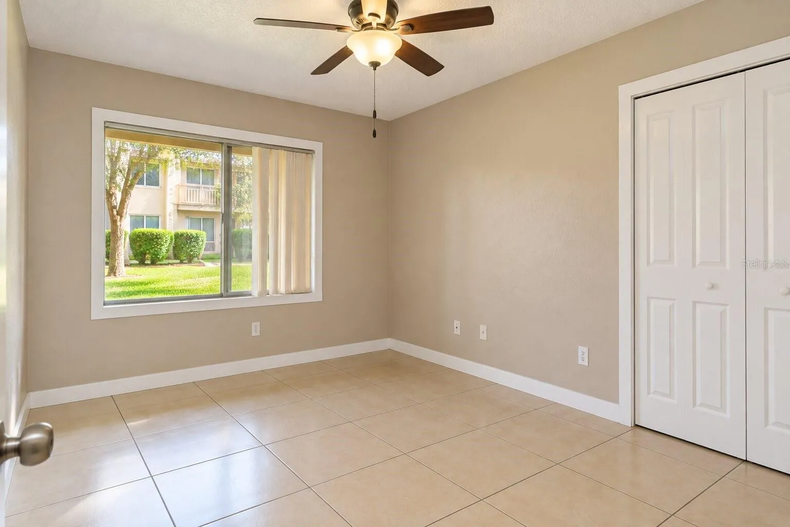 Bedroom with tile flooring and closet space