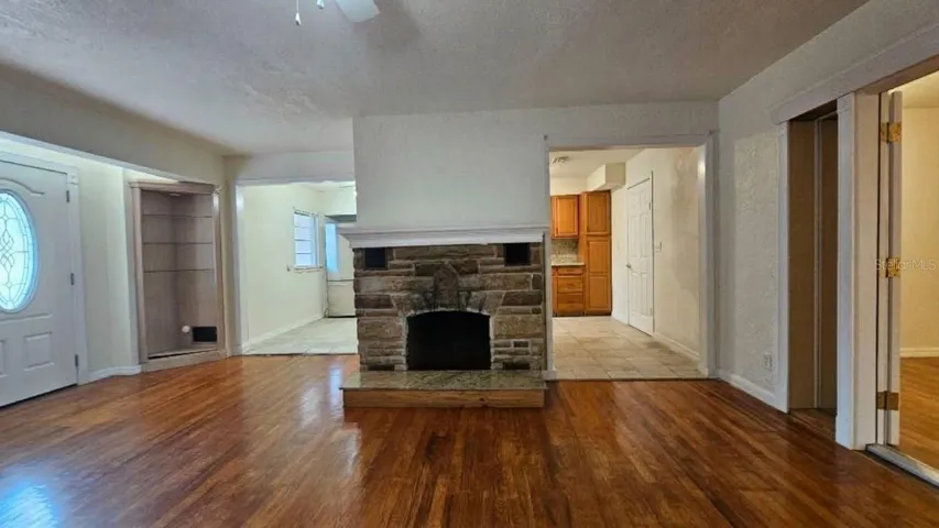 Living room facing wood burning fire place