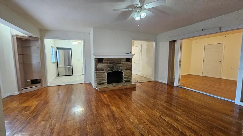 Living room with kitchen behind and family room on right
