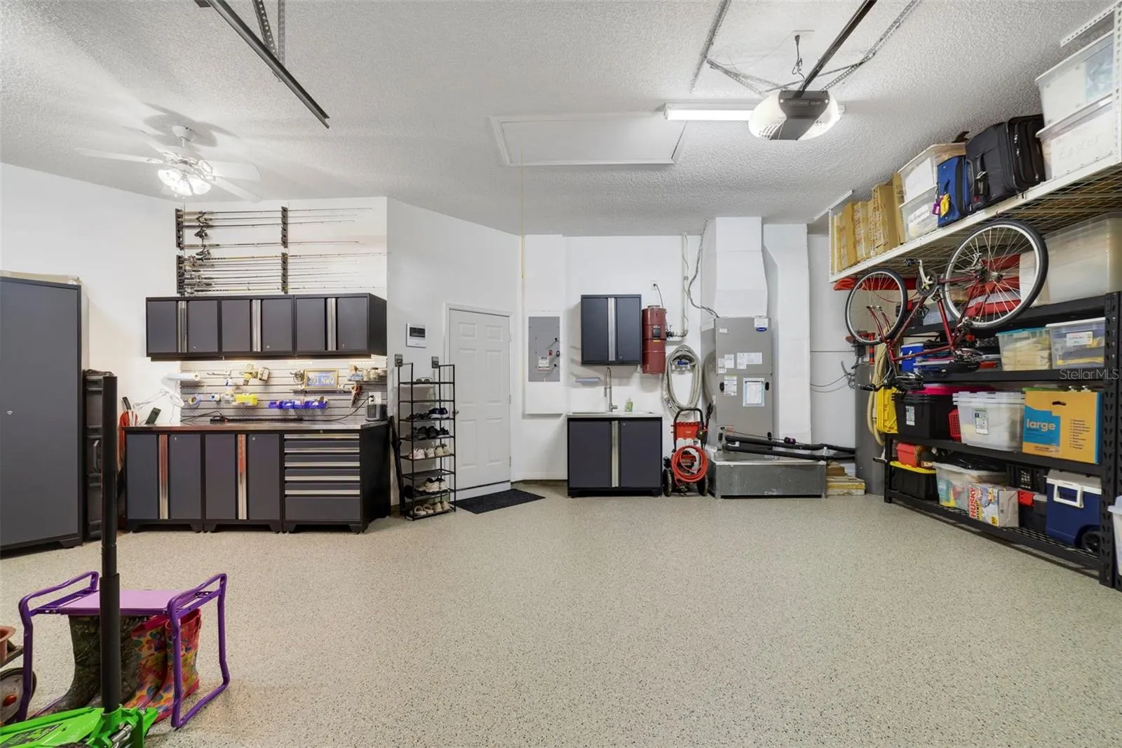 Another view of this magnificent garage space with custom workshop and storage shelves