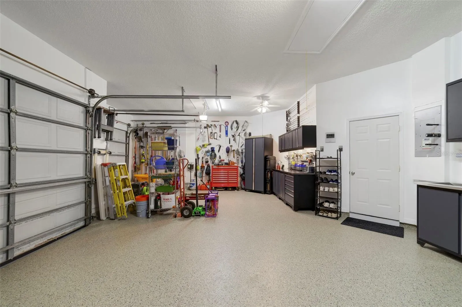 Immaculate garage with tech floor finish/S/S Cabinets, plenty of storage !!