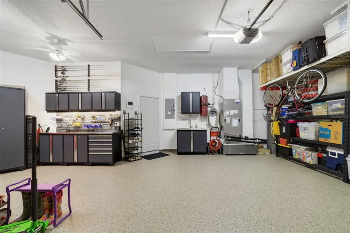 Another view of this magnificent garage space with custom workshop and storage shelves
