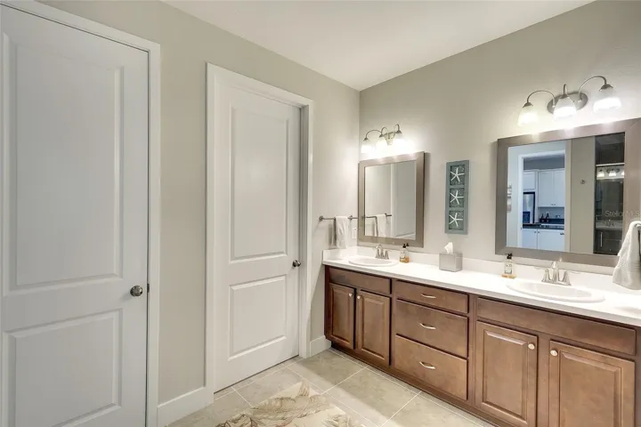 Owner's bath with double vanities, decorative lighting and accents, large walk in closet and OVERSIZED linen closet.