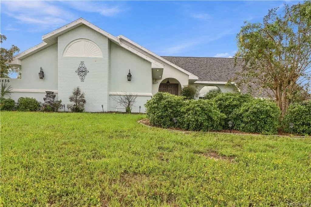 FRONT ELEVATIONAttractive front elevation featuring decorative architectural accents, mature landscaping & a welcoming arched entryway.