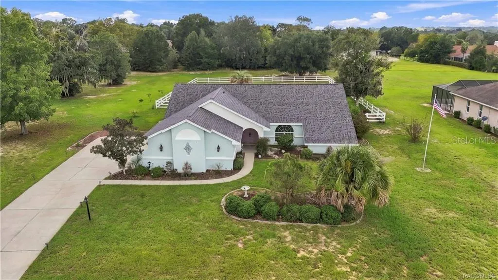 Aerial Front View – Elevated perspective showcasing the home's attractive roofline, landscaping & generous homesite.