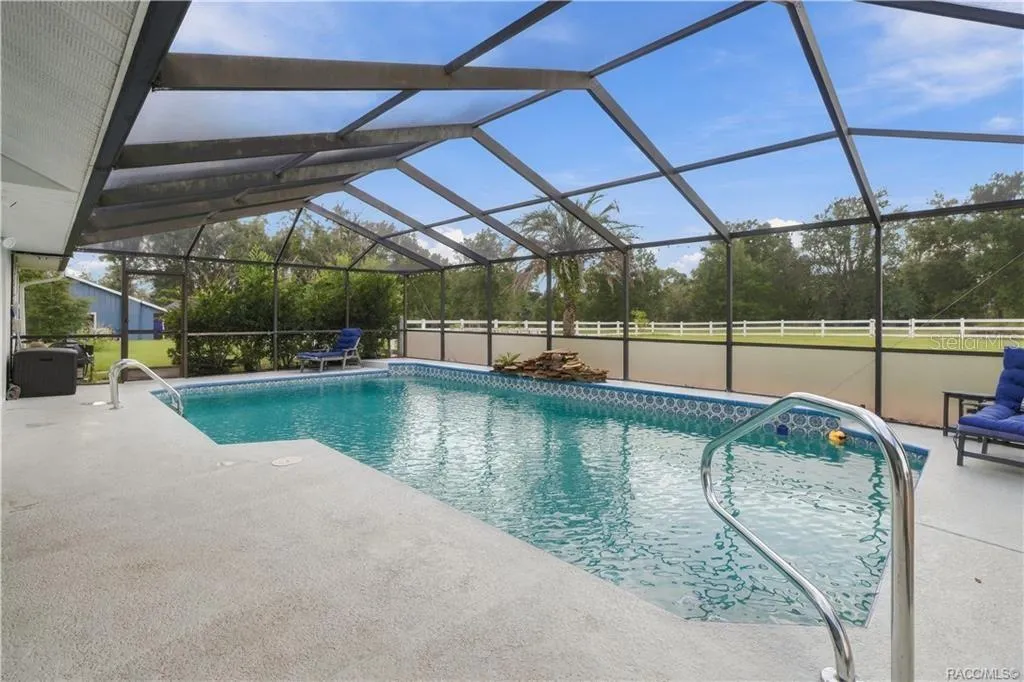 Florida Poolside Living – Generous pool decking offers room for lounge chairs, entertaining & enjoying sunny Florida afternoons.