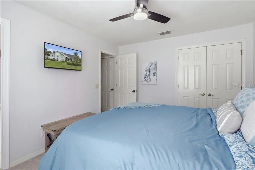 Bedroom – Bright, comfortable bedroom featuring neutral walls, carpeting, a ceiling fan & closet space.