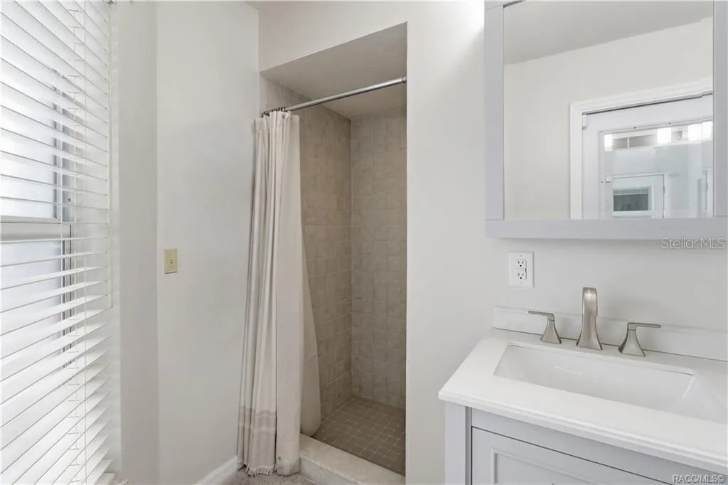 Primary Bathroom Walk-In Shower – Tiled walk-in shower featuring neutral finishes, conveniently located within the primary bathroom.