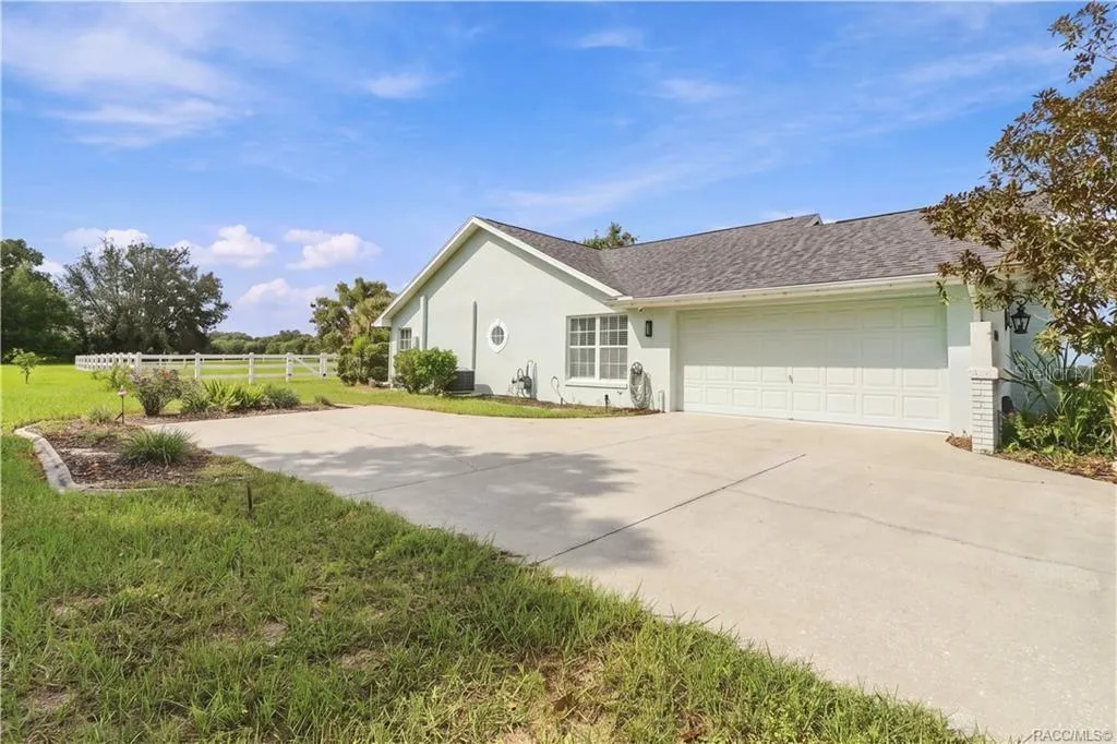 Garage & Driveway – Attached 2-car garage w/an expansive concrete driveway offering additional parking space.