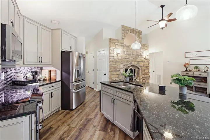 KITCHEN ADDITIONAL VIEW- Beautiful kitchen featuring a large granite island w/double-basin sink, abundant cabinetry, newer appliances & updated flooring.