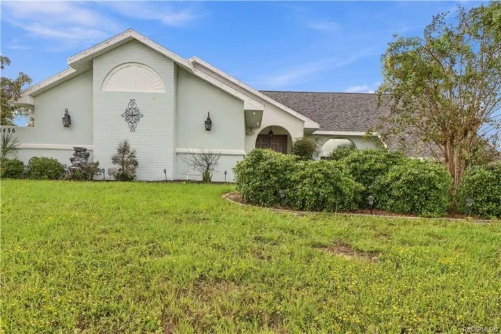 FRONT ELEVATIONAttractive front elevation featuring decorative architectural accents, mature landscaping & a welcoming arched entryway.