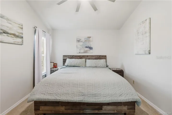 Primary Bedroom – Comfortable primary suite featuring vaulted ceilings, a ceiling fan, neutral finishes.