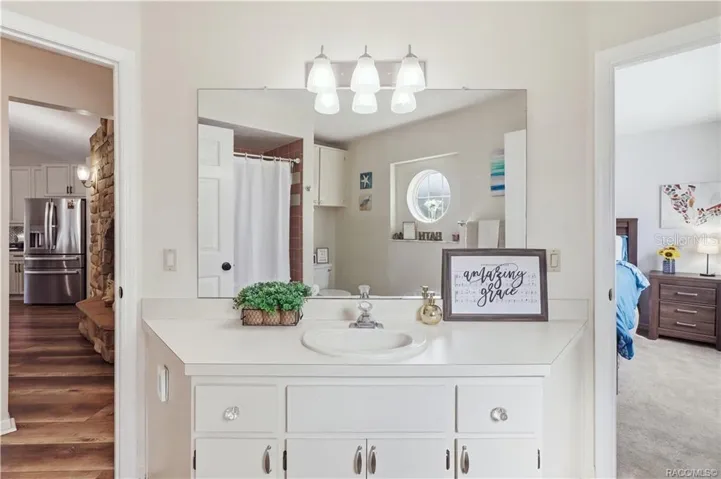 Guest Bathroom Vanity – Spacious vanity area w/a large mirror, countertop space & cabinetry for everyday storage.