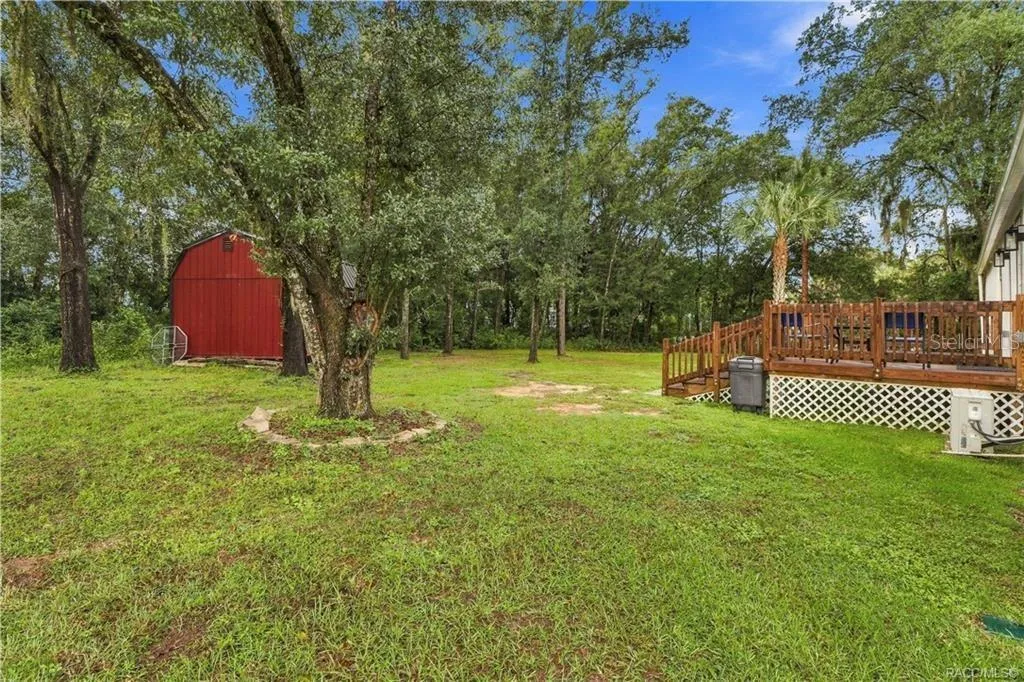 Spacious Backyard – Enjoy the natural setting w/mature shade trees, green lawn, wooden rear deck &amp; detached storage building. Plenty of outdoor space to enjoy!