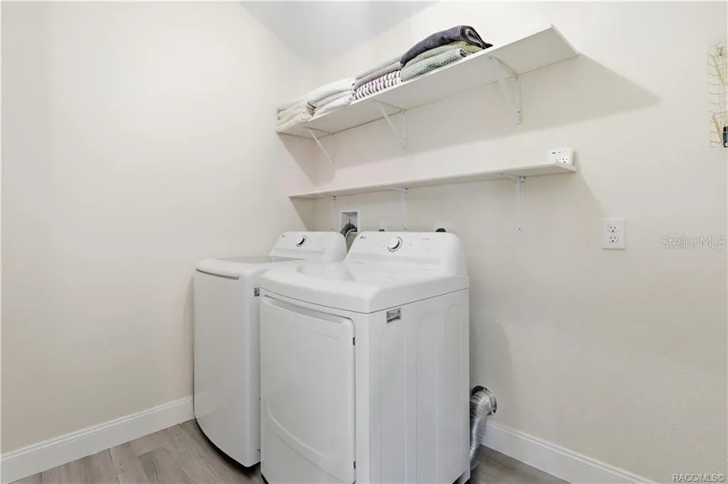 Indoor Laundry Room – Convenient INDOOR LAUNDRY featuring a washer, dryer &amp; overhead shelving for additional storage. Everything has its place!
