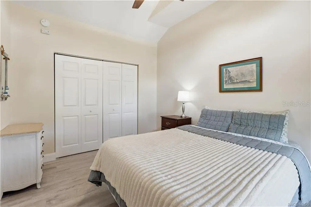 Bedroom – Comfortable bedroom featuring VAULTED CEILINGS, luxury vinyl plank flooring, ceiling fan, spacious double closets &amp; attractive furnishings.