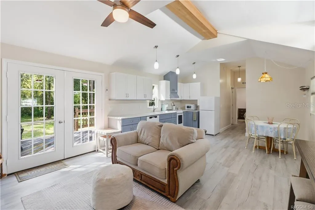 Open Kitchen &amp; Living Space – VAULTED CEILINGS, pendant lighting, attractive cabinetry &amp; an open design create a bright, comfortable gathering space.