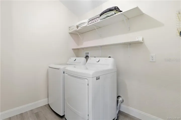 Indoor Laundry Room – Convenient INDOOR LAUNDRY featuring a washer, dryer &amp; overhead shelving for additional storage. Everything has its place!
