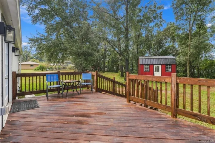 Rear Deck – Step outside &amp; enjoy the spacious WOODEN REAR DECK overlooking the backyard! A wonderful spot for morning coffee, outdoor conversation or relaxing beneath the surrounding trees.