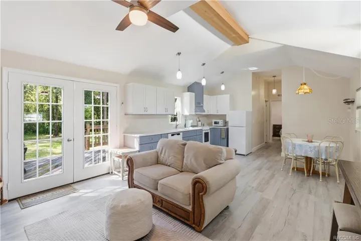 Open Kitchen &amp; Living Space – VAULTED CEILINGS, pendant lighting, attractive cabinetry &amp; an open design create a bright, comfortable gathering space.