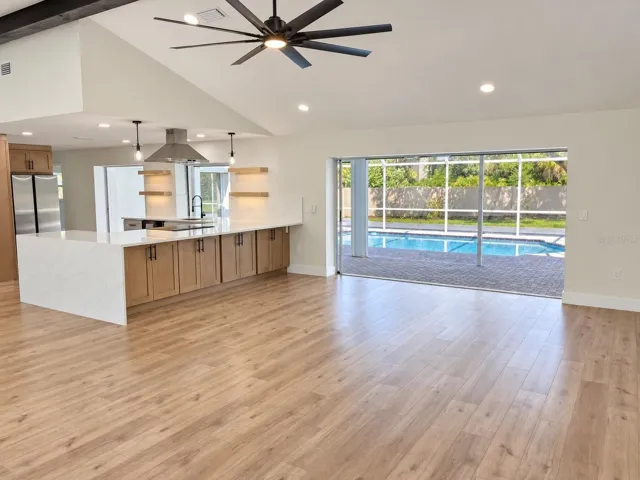 Living area with kitchen and pool access
