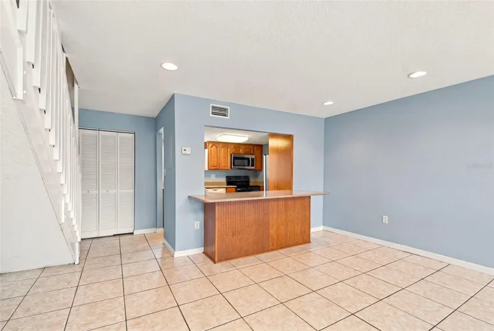 Kitchen counter with stairs to loft on left