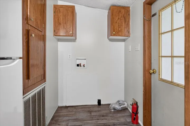 Utility area with overhead cabinets for even more storage space