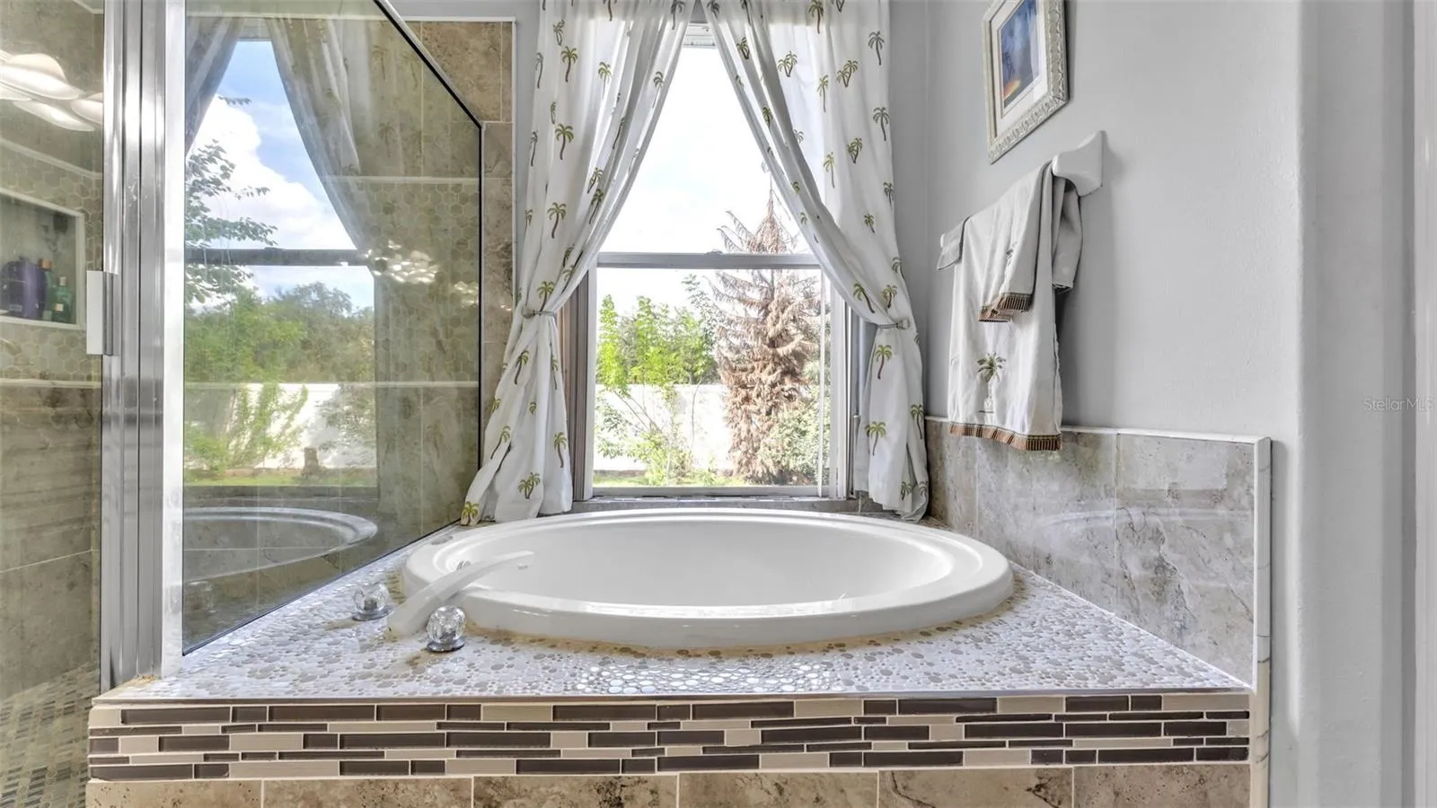 Beautiful remodeled ensuite bathroom with soaking tub, walk-in shower, double vanities, and private toilet room