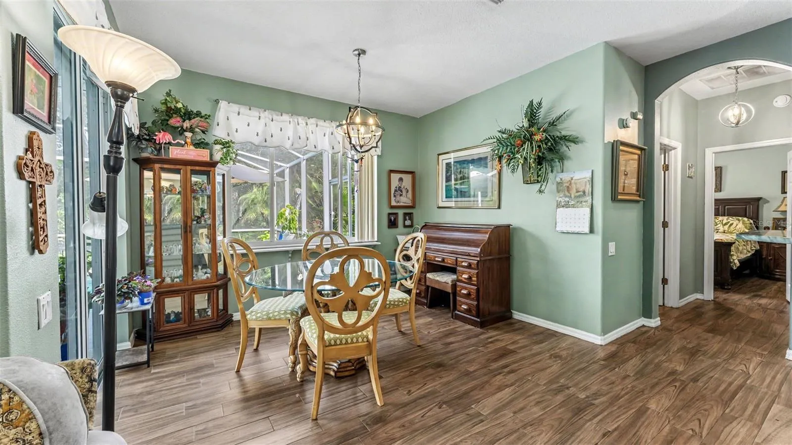 dinette just off the kitchen with picture window looking out to the pool and backyard