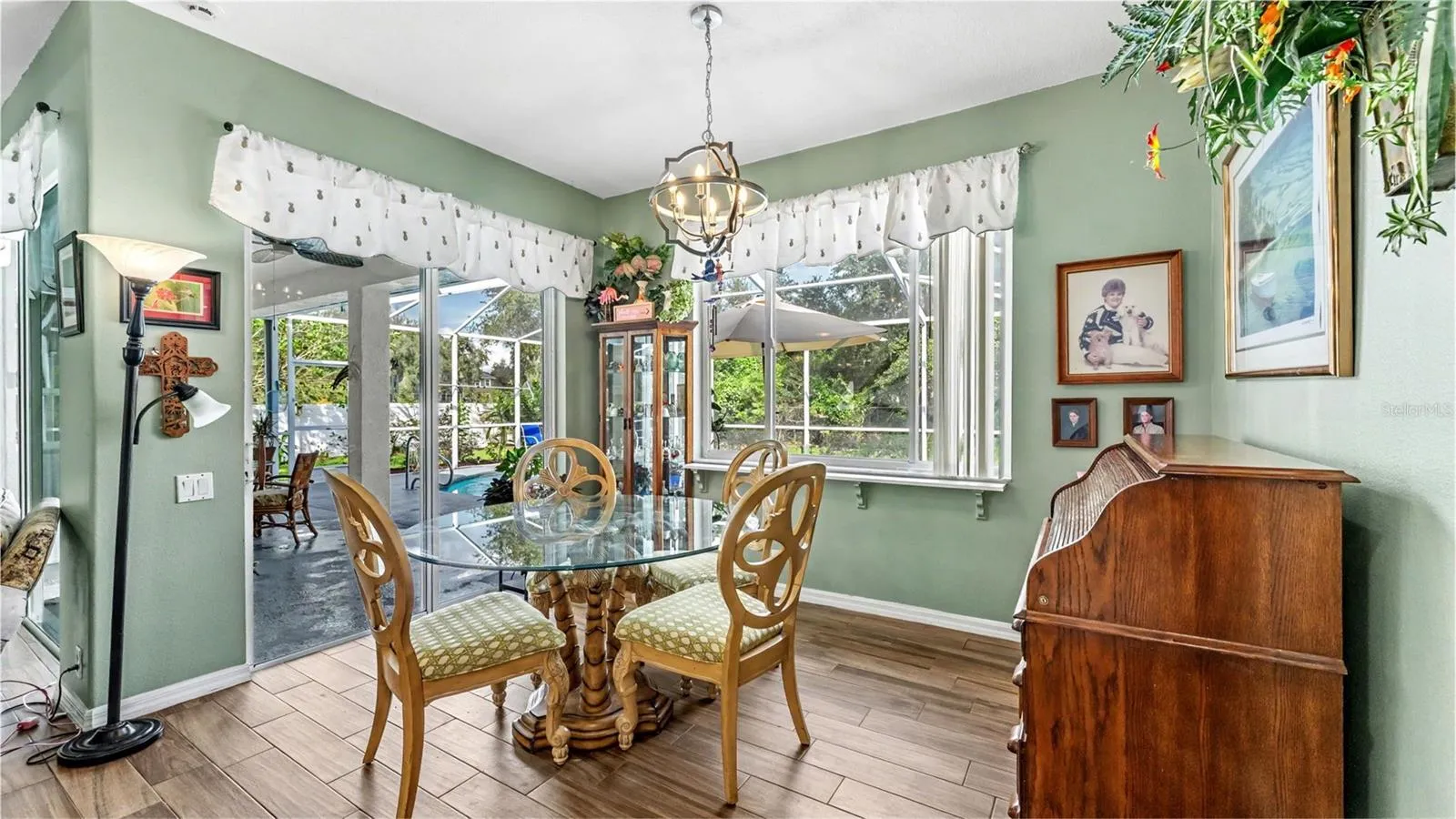 dinette just off the kitchen with picture window looking out to the pool and backyard