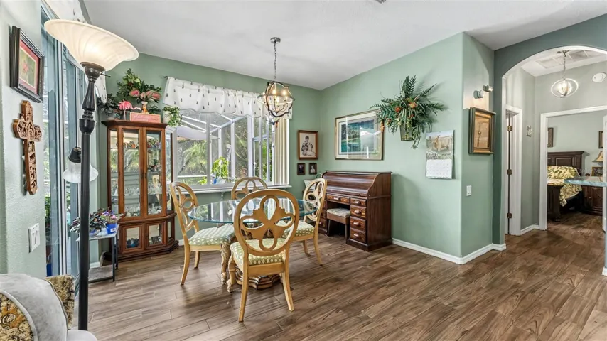 dinette just off the kitchen with picture window looking out to the pool and backyard