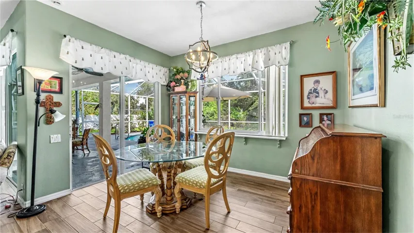 dinette just off the kitchen with picture window looking out to the pool and backyard