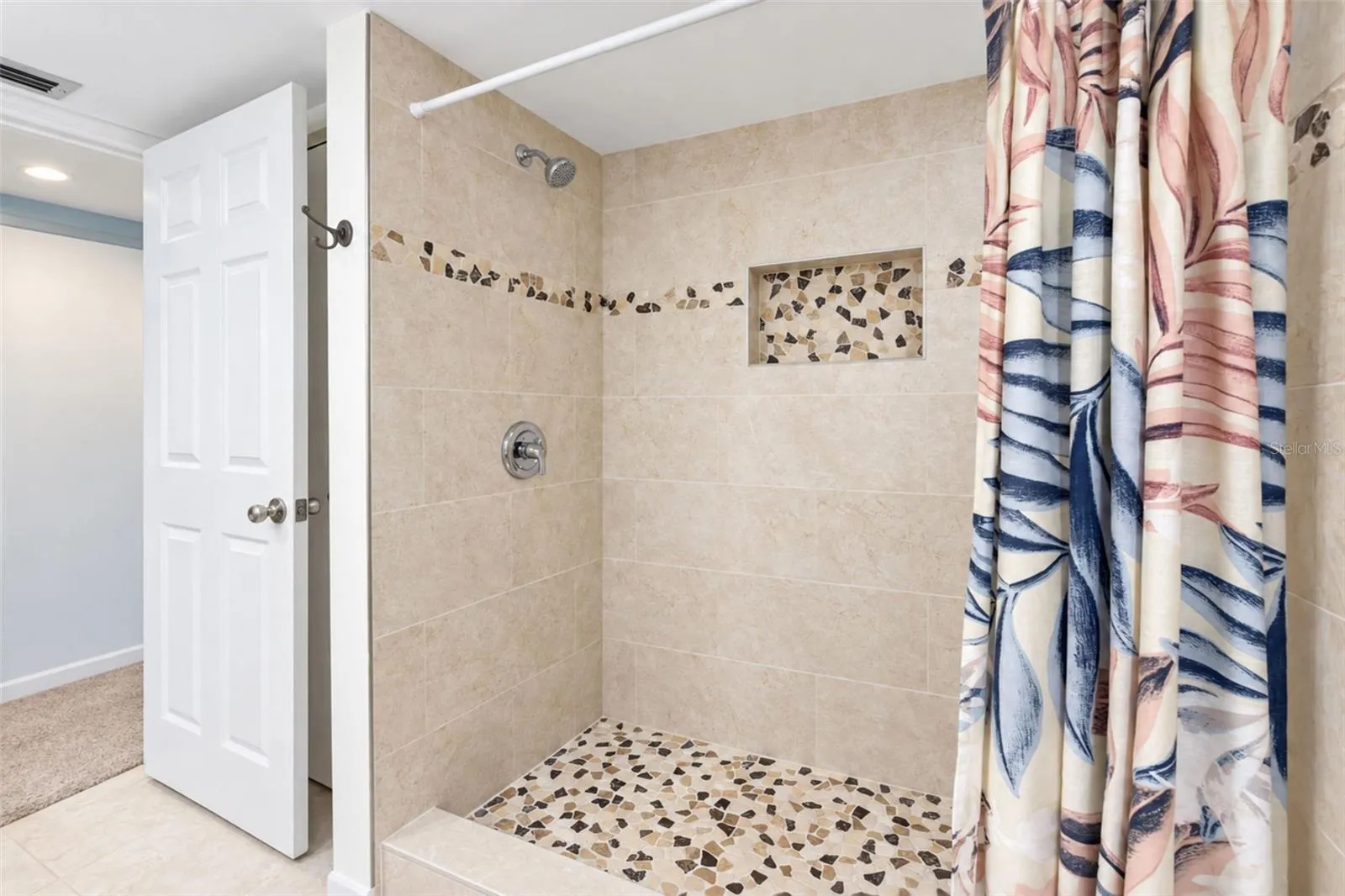 The primary bathroom features an updated shower.