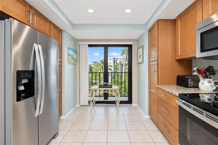 The kitchen has a stainless steel double door Whirlpool refrigerator and a French balony.