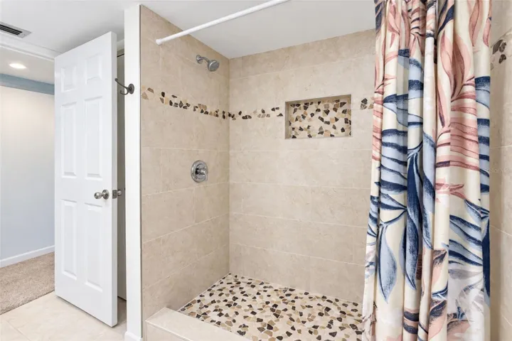 The primary bathroom features an updated shower.