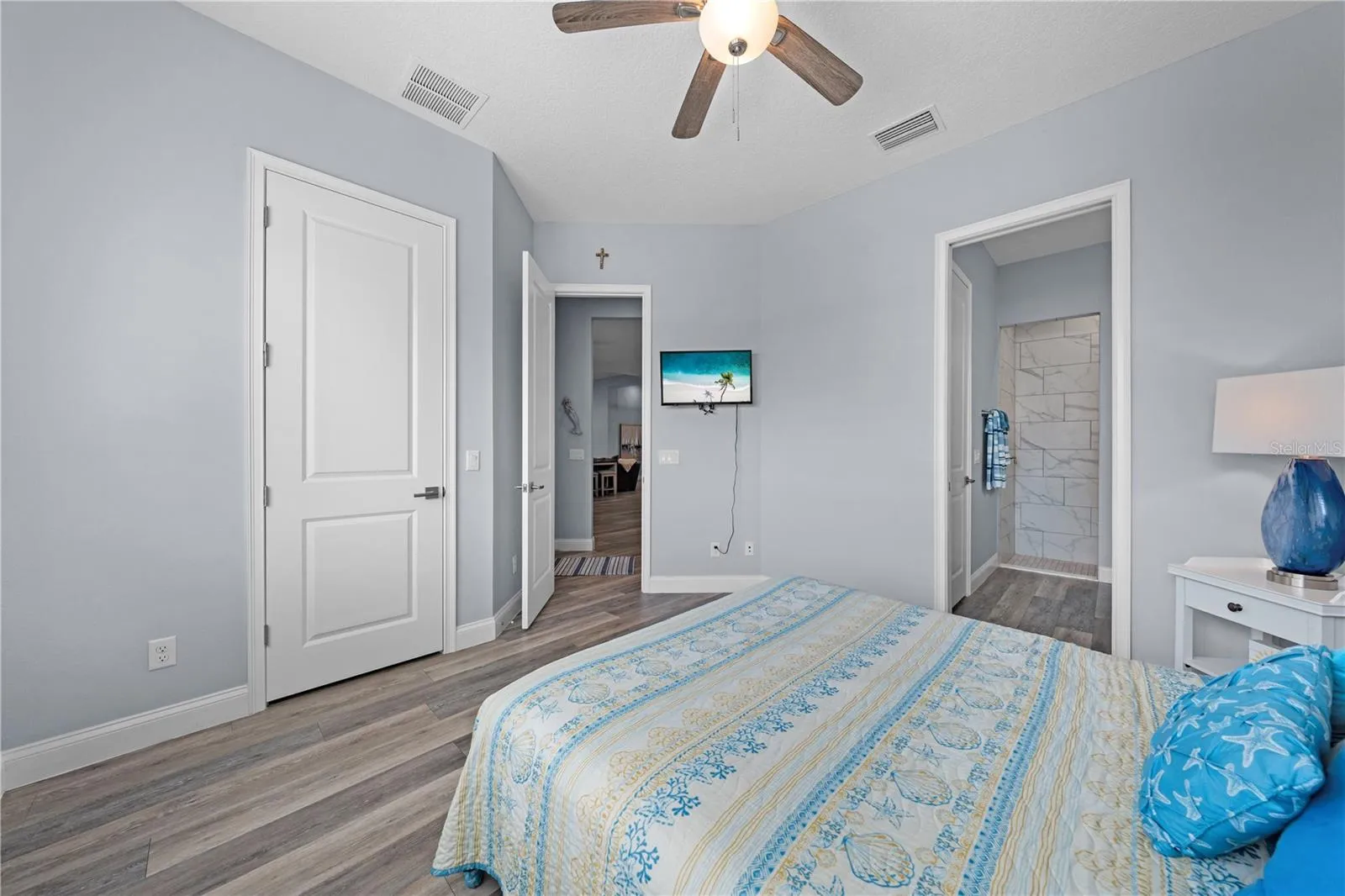 2nd primary bedroom with plantation shutters overlooking the lake