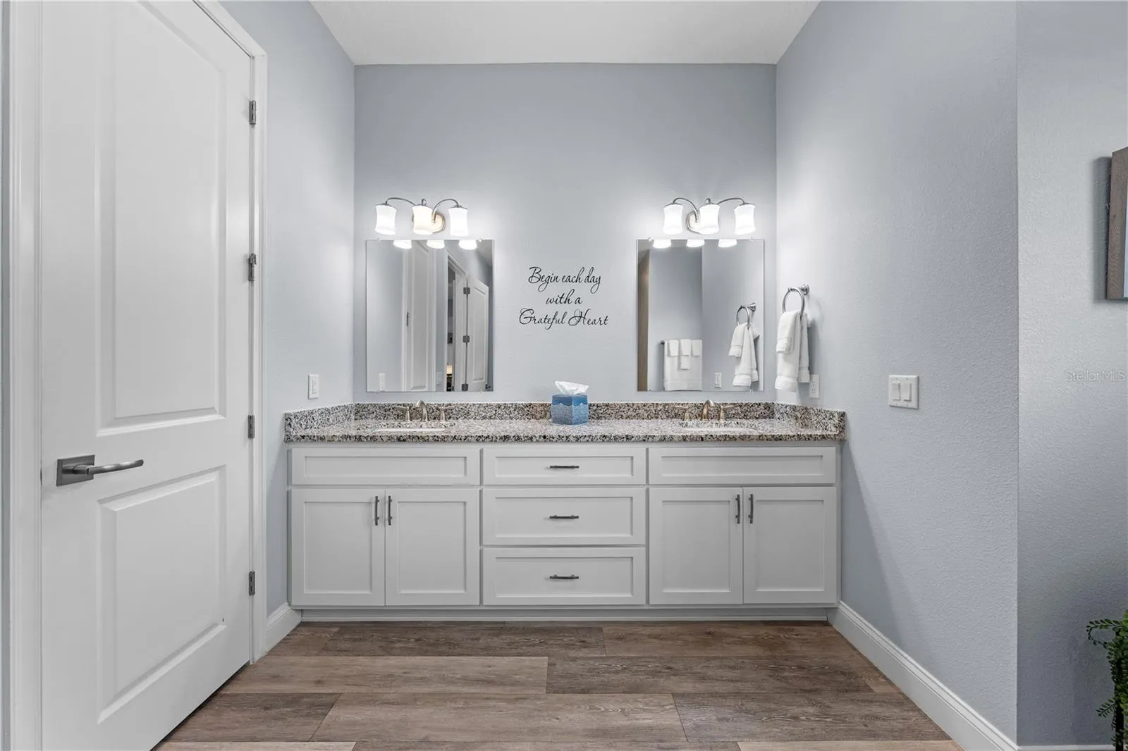 Primary bathroom granite countertop with double vanity