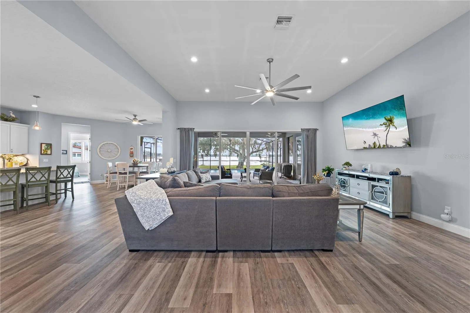 Open floor plan with family room, large ceiling fan and great view of the lake.