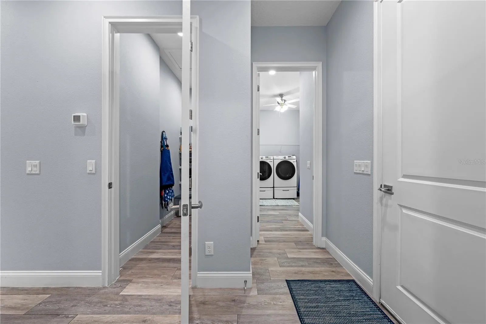 Entrance to the pantry on the left and laundry room on the right.