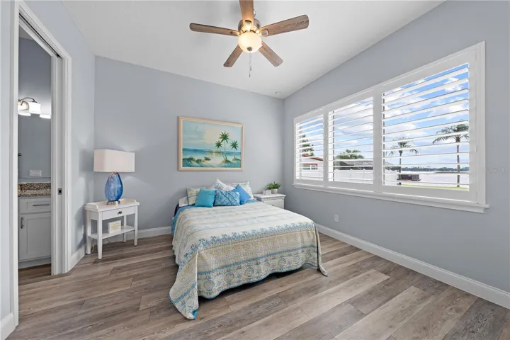2nd primary bedroom with plantation shutters overlooking the lake