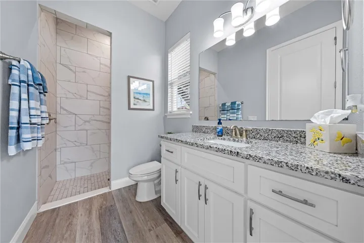 2nd primary bathroom with granite with single vanity and rain showerhead