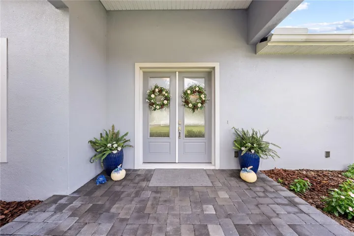 Double entrance doors and brick paver entrance.