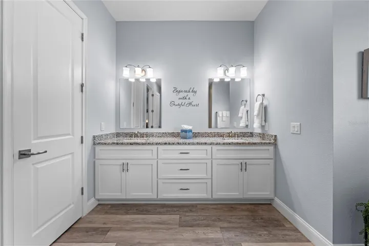 Primary bathroom granite countertop with double vanity