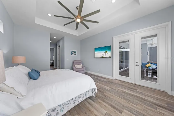 Primary Bedroom with double entry doors to the lanai