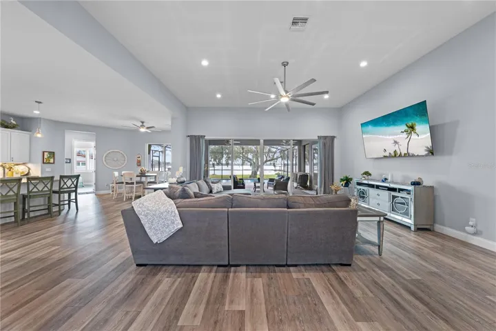 Open floor plan with family room, large ceiling fan and great view of the lake.