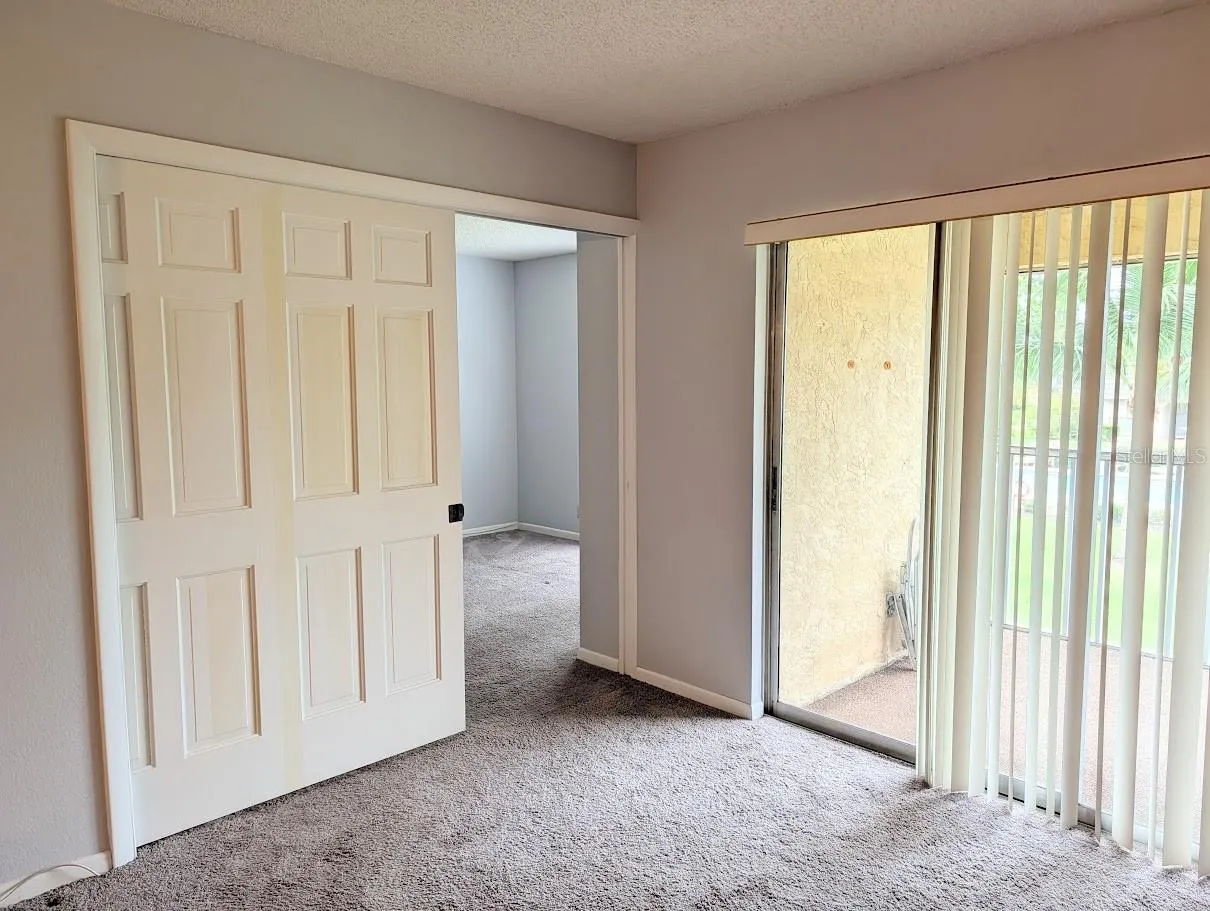 Entry to 2nd bedroom with pocket door partially closed