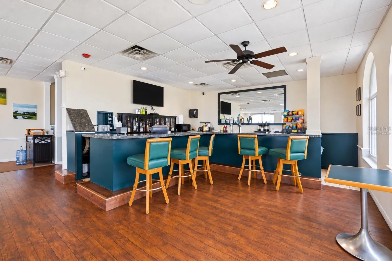 Clubhouse bar, virtually staged, table cleared and TV darkened