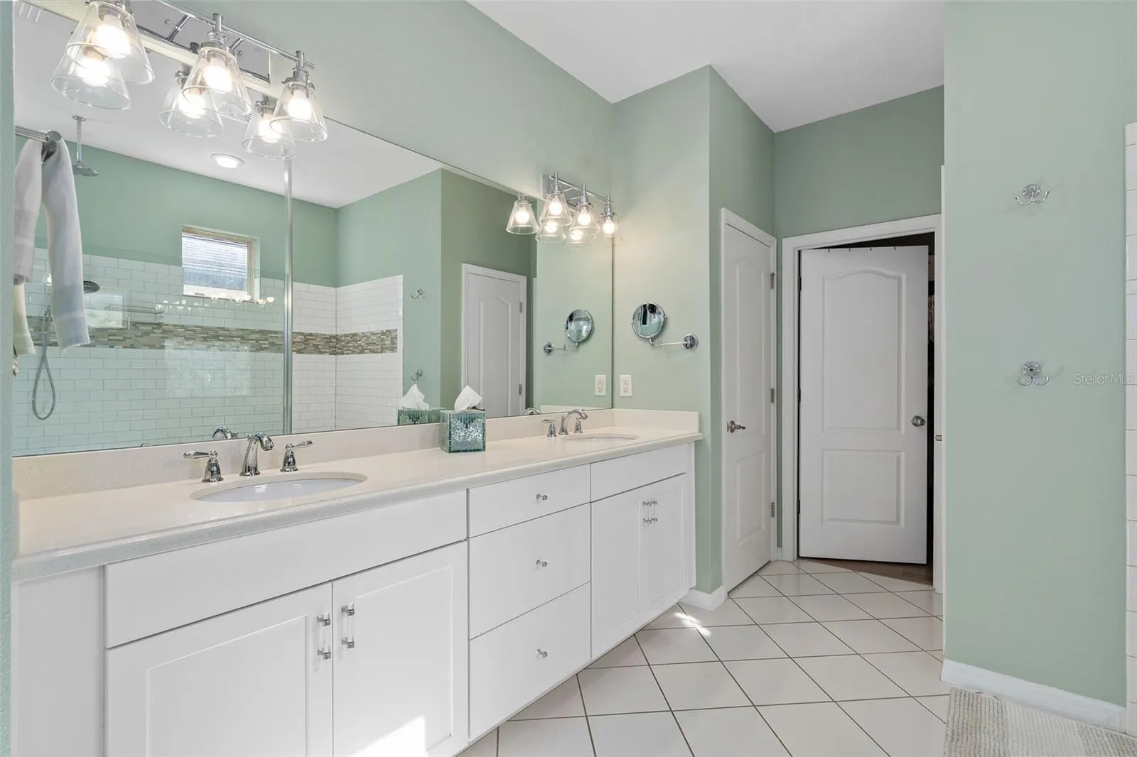 The Primary En-Suite Comfort Height Vanity offers additional center drawers for storage